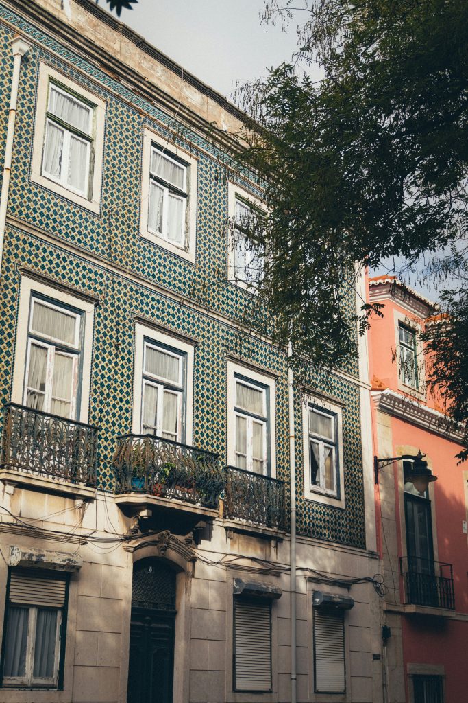 Lisbon Buildings Portugal with blue and yellow tiles. Many hostels in Portugal are in buildings like these