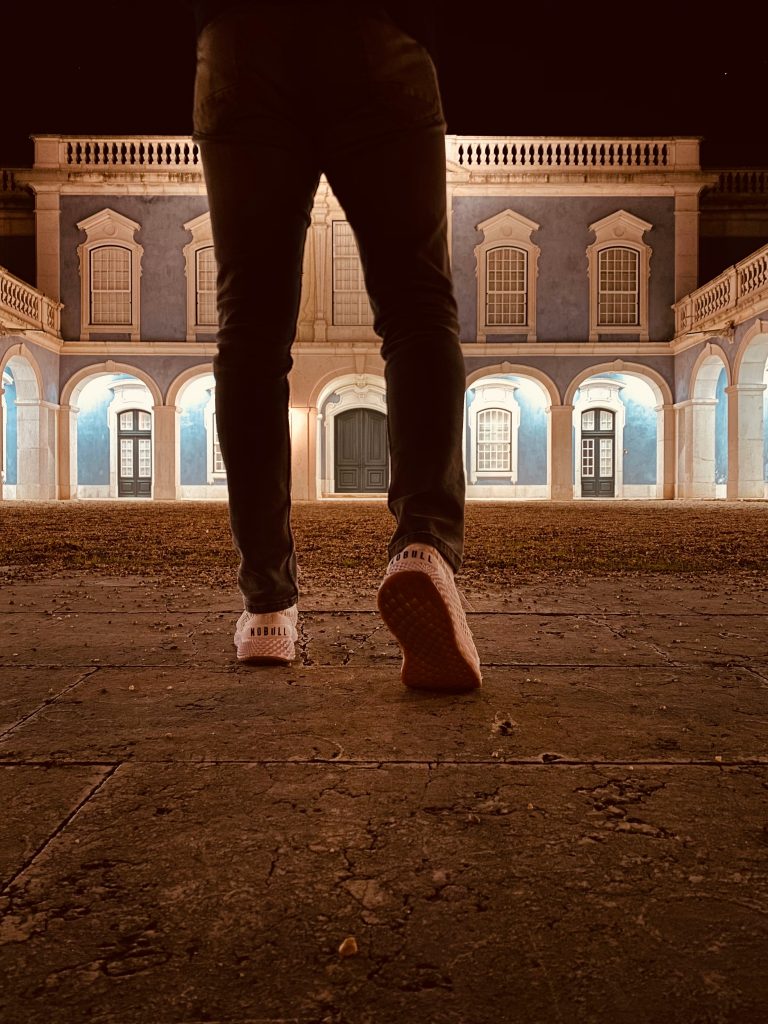 Palace of Queluz in Lisbon with person walking towards the entrance