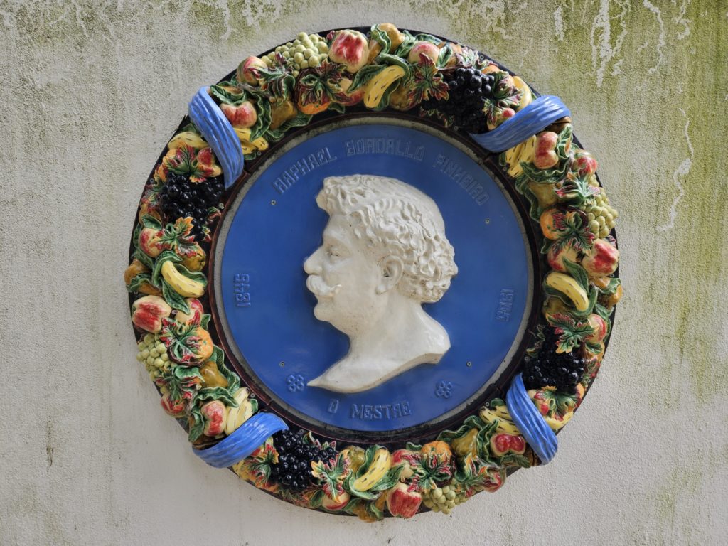 Design of the face of Rafael Bordallo Pinheiro, with painted flowers around, in one of the garden's walls, Palace Pimenta, Lisbon