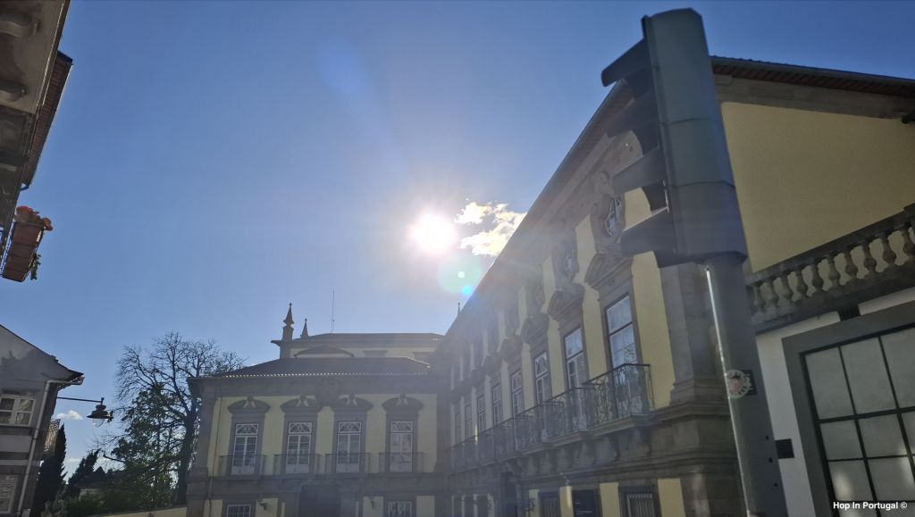 Sun behind buildings in Braga